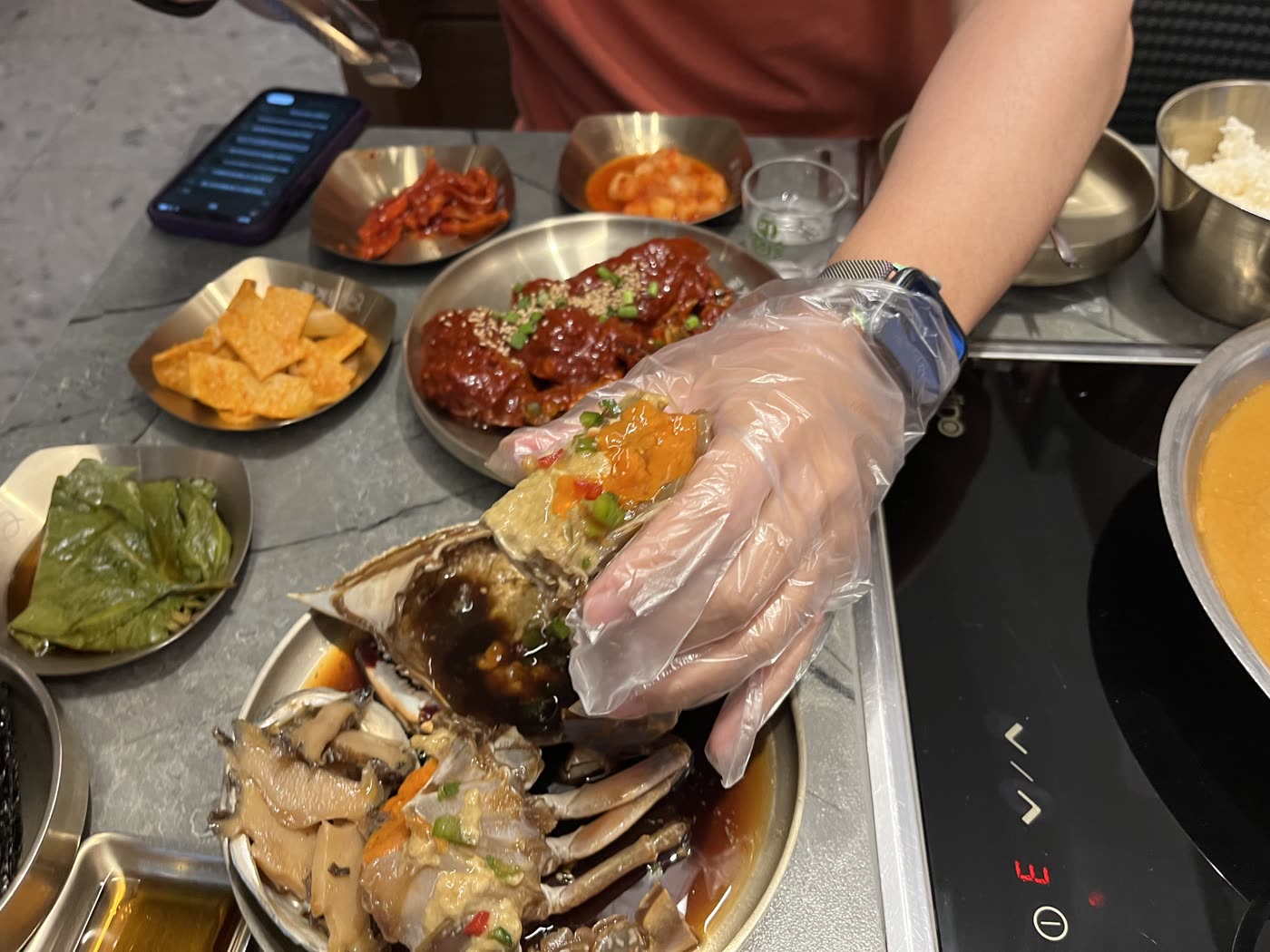 Holding up the crab shell before the rice goes in