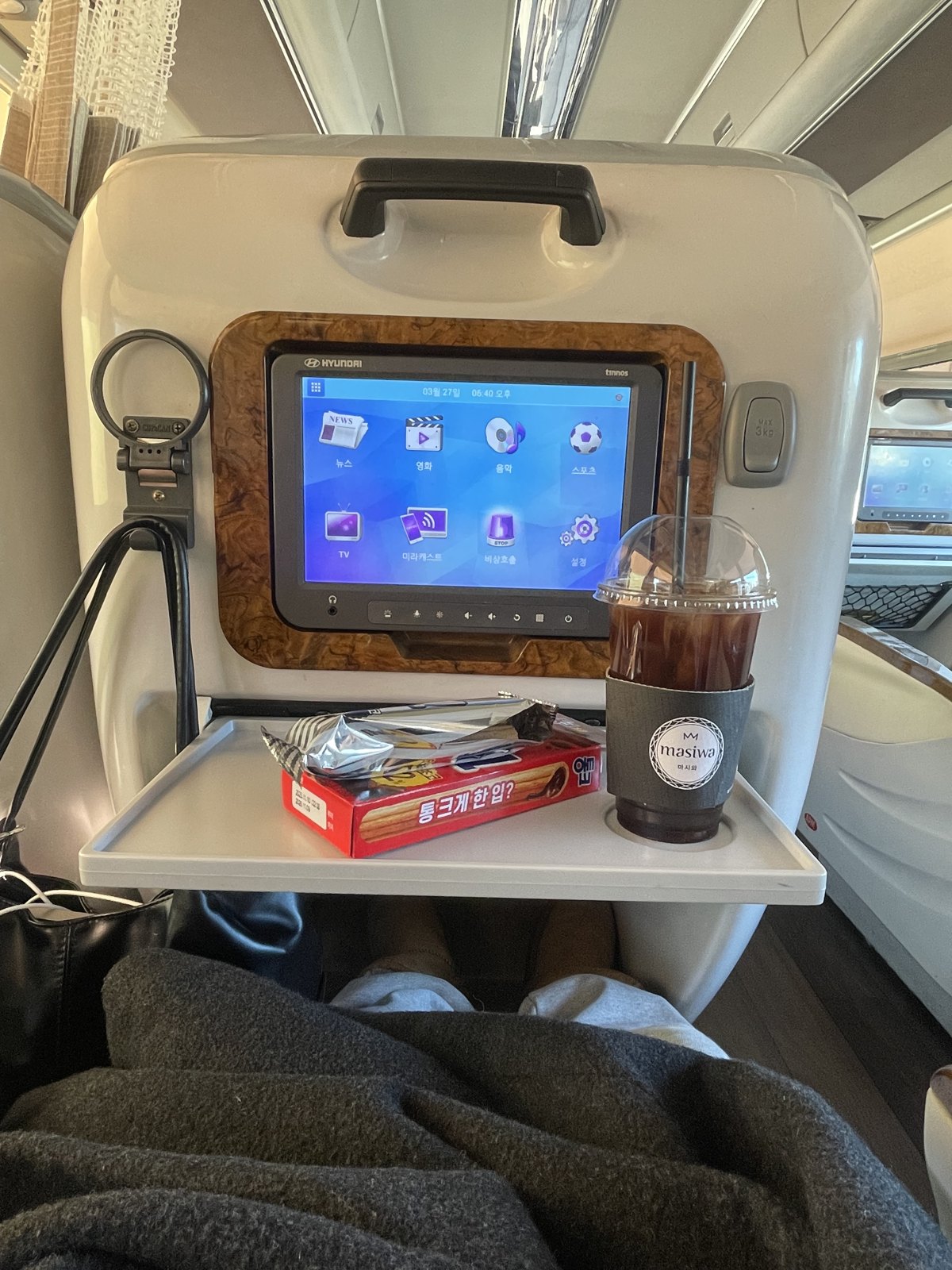 The premium express coach from Seoul: reclining seat, blanket, tray and a seatback screen.