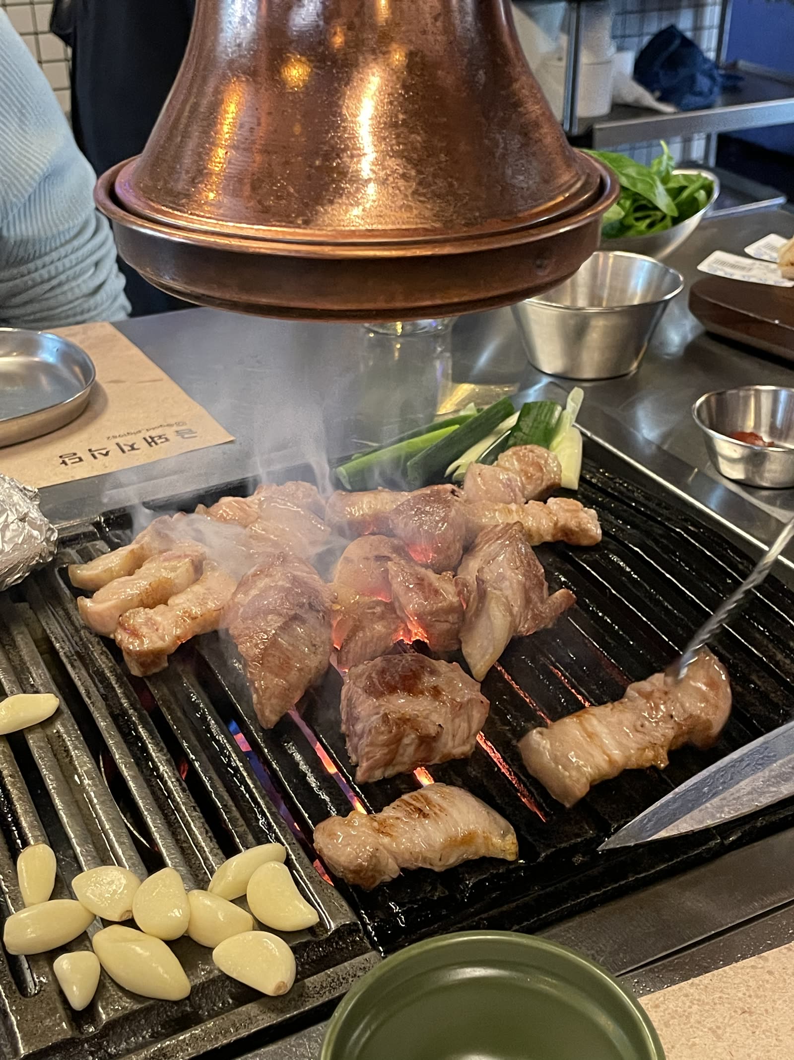 Under the copper hood at Geumdwaeji Sikdang. Photo by Jeong, Korea