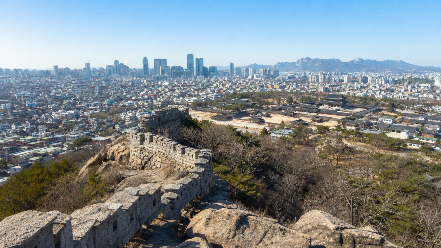 The old fortress wall runs down the ridge, with central Seoul below.