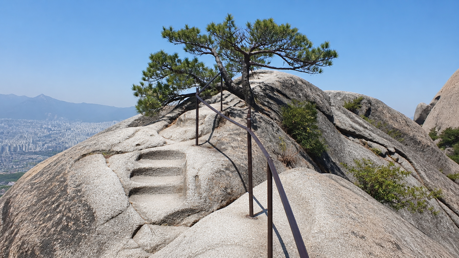 The upper section is bare granite with handrails. Slippery when wet.