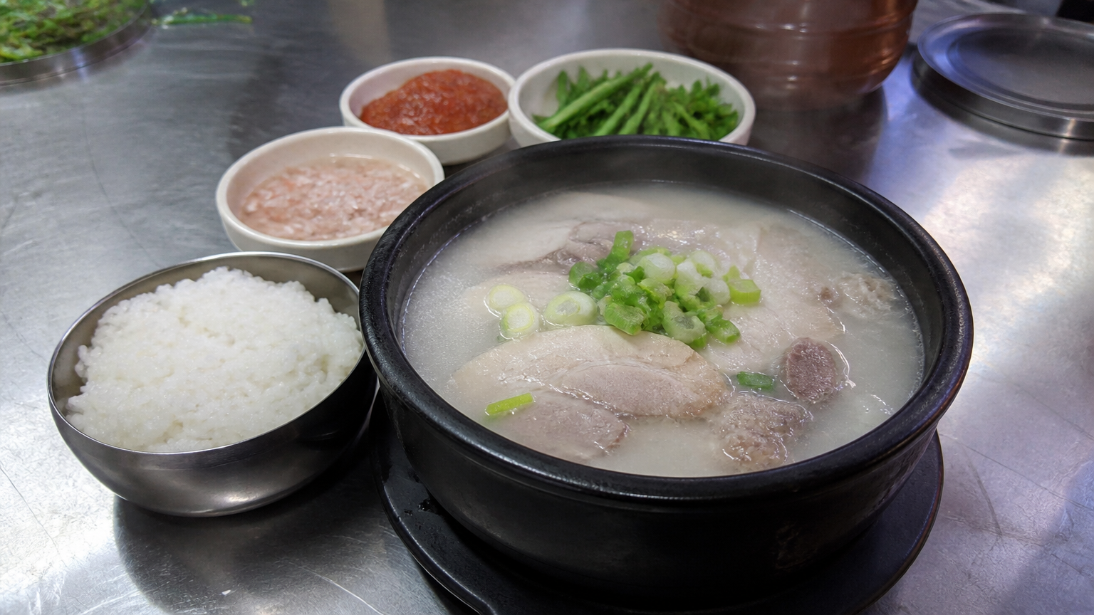 Dwaeji gukbap — pork and rice soup, the dish Busan is built on.