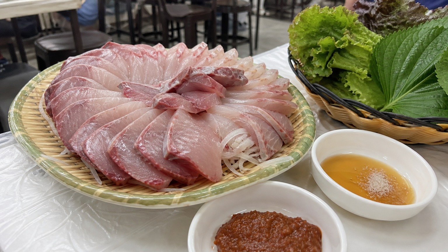 Raw fish with sesame oil and salt — real, local, and occasional.