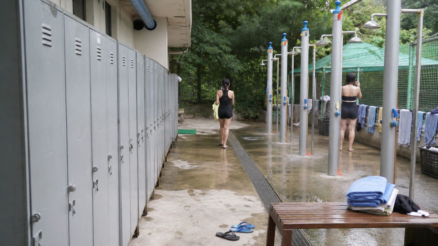 Lockers, rinse showers, wet concrete. Functional rather than luxurious. Illustrative image.