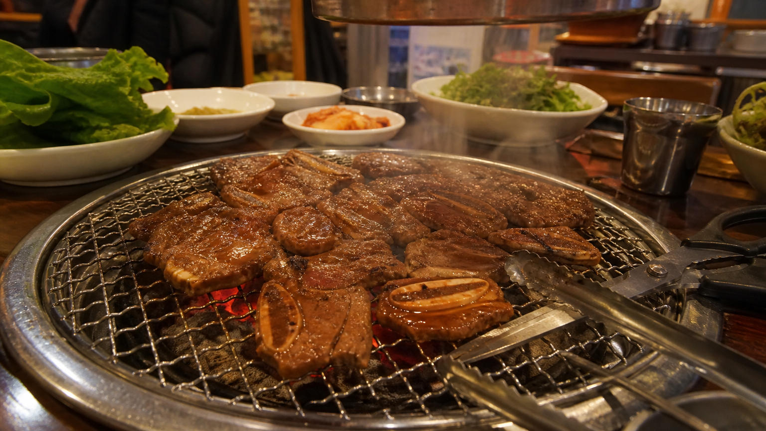 Marinated ribs over charcoal at a table grill. Illustrative image.
