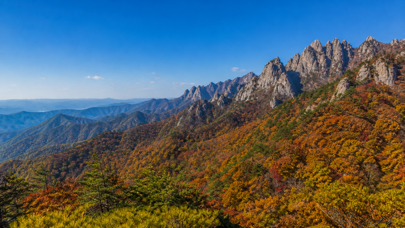 A Korean mountain range at full colour — the northeast turns first