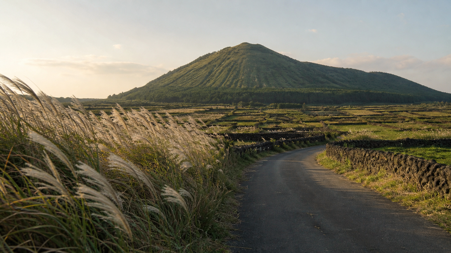 An oreum above stone-walled fields — the reason people put Jeju on the itinerary.